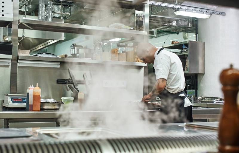 man cooking in commercial kitchen